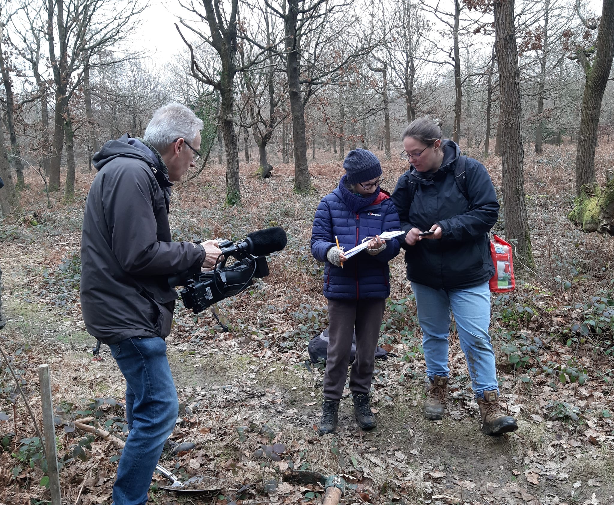 Film crew with Hayley green and white bird on gray wood